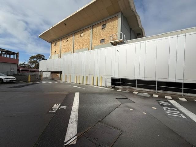 Wide view of the ALPOLIC™ façade upgrade beneath the existing brick building
