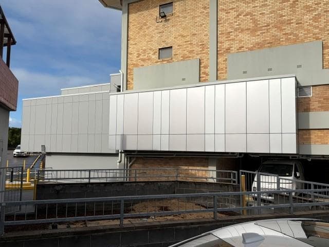 ALPOLIC™ metallic cladding installed across the club’s rear service façade
