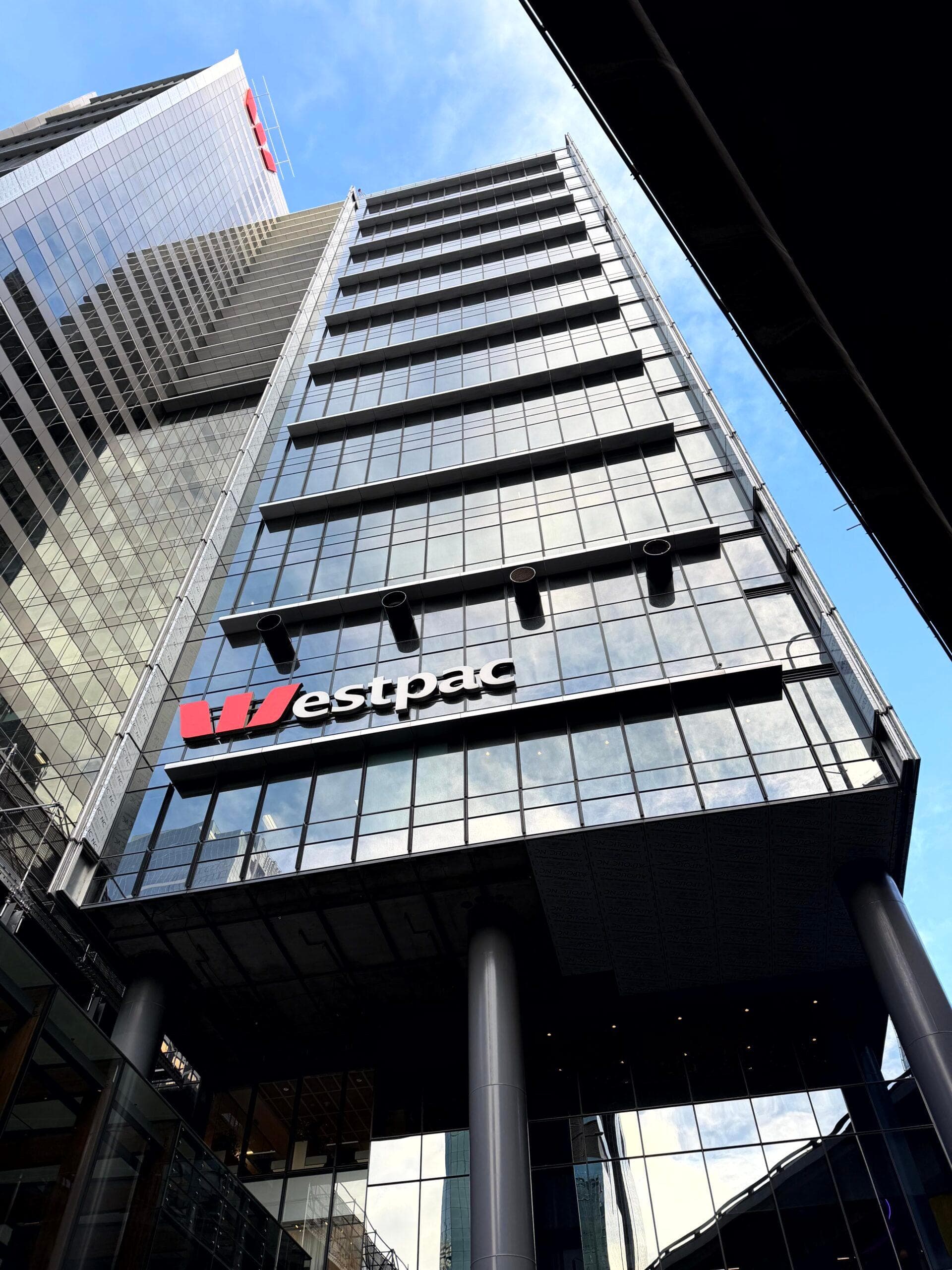 Low-angle view of Westpac Place entrance façade with signage and ALPOLIC™ panels