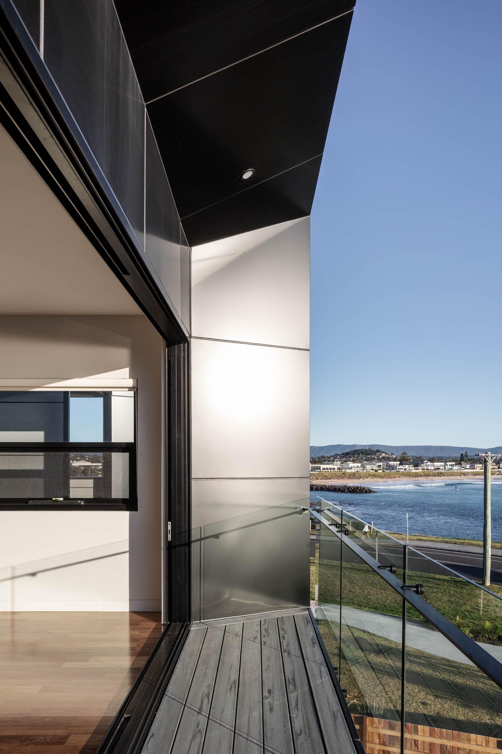 Coastal balcony view framed by ALPOLIC™/fr Monotone Slate cladding overlooking Barrack Point beach