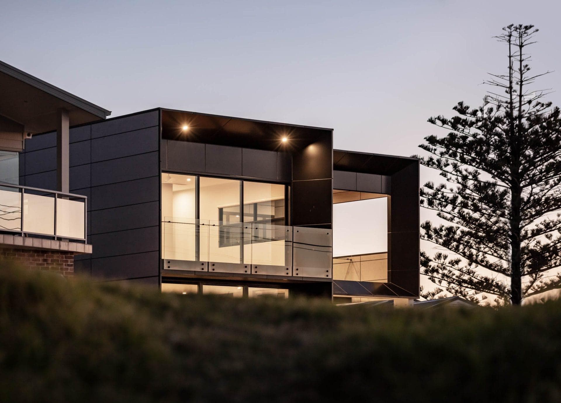 Low-angle view highlighting ALPOLIC™/fr cladding and glass balconies against coastal skyline